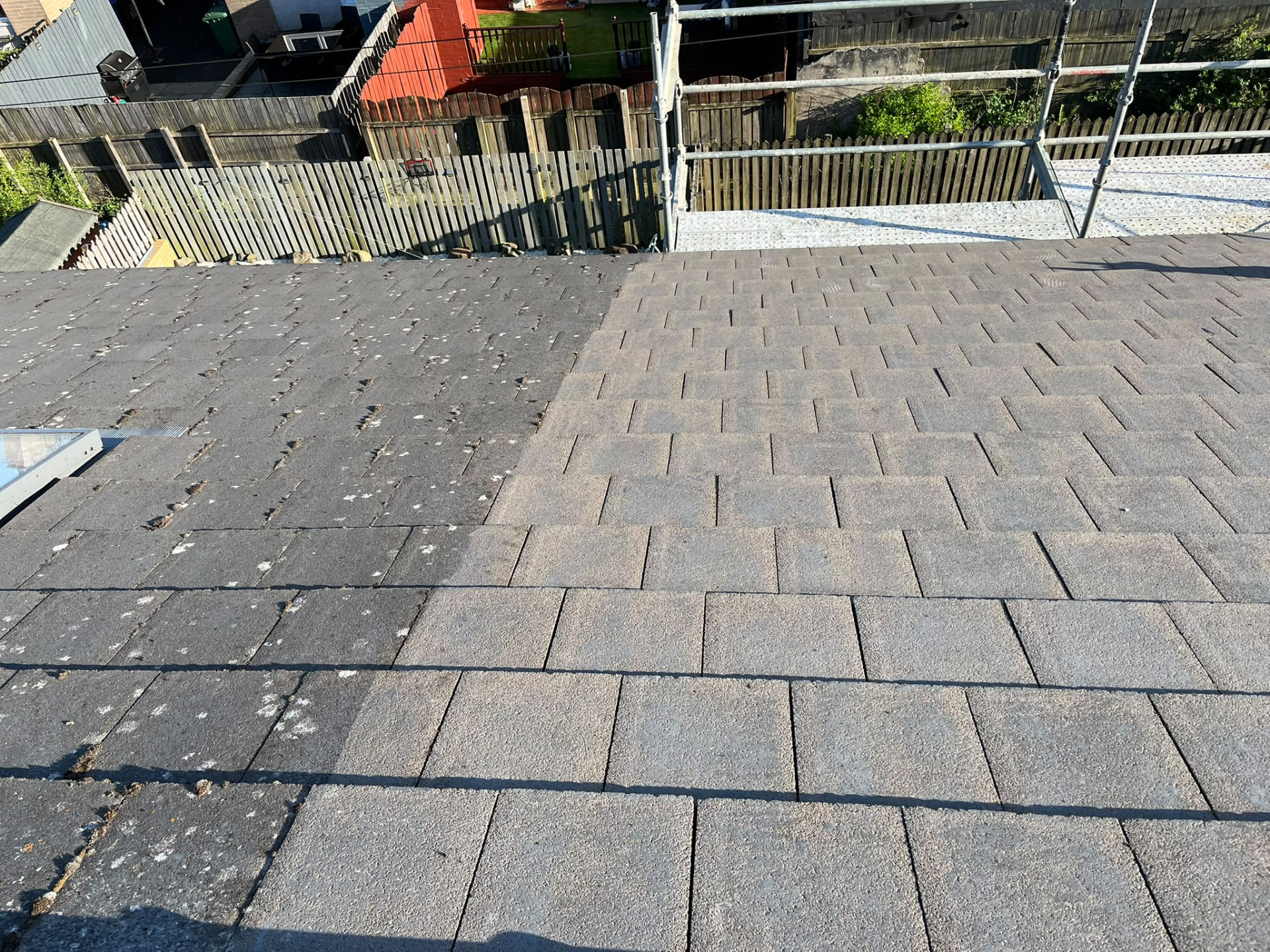 Roof tiles half cleaned showing before and after